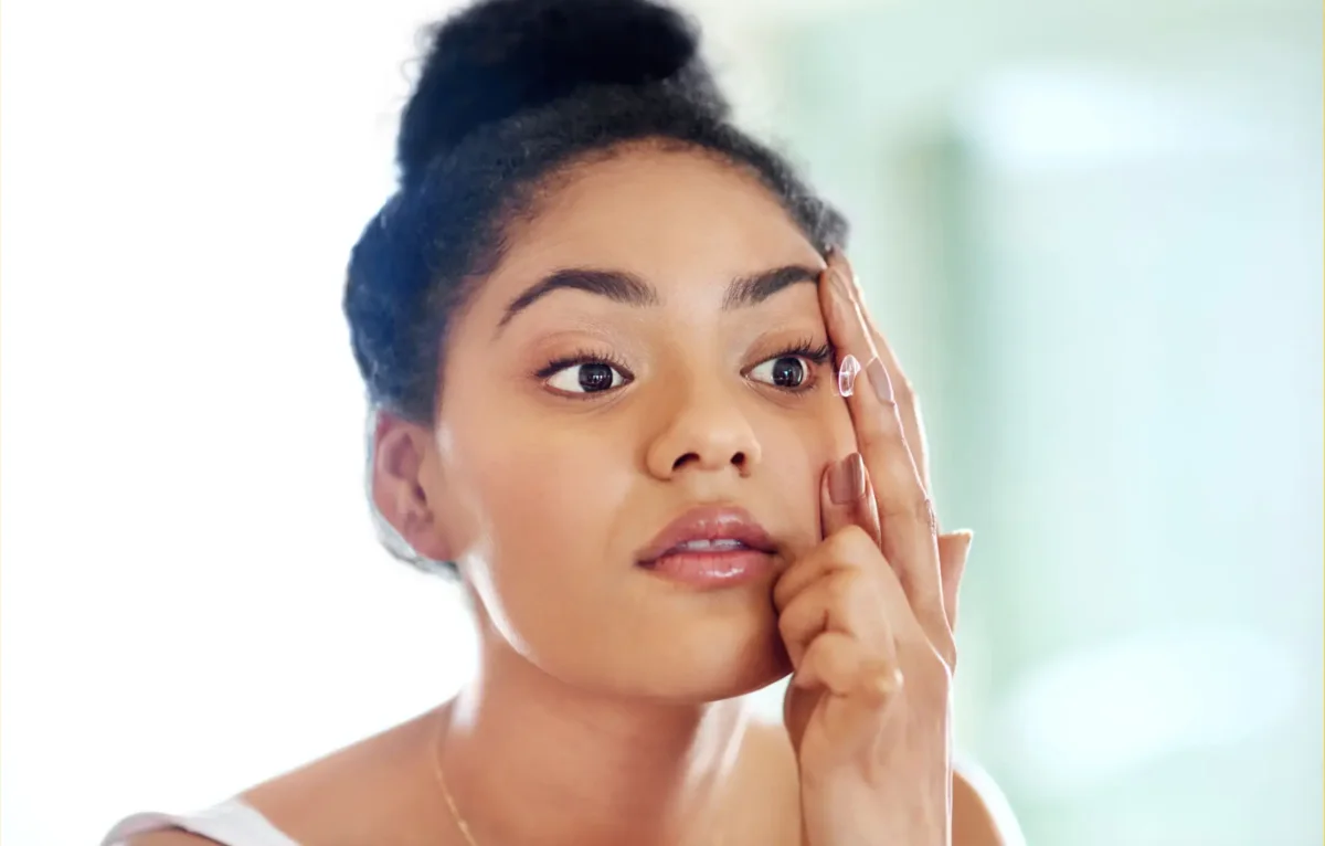 A person handling a contact lens